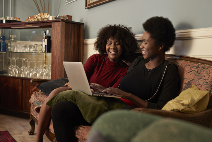 Young women ordering Christmas gifts online with creditcard